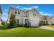 Two-story home featuring beautiful curb appeal, a two-car garage, and manicured landscaping at 5226 Northern Flicker Dr, St Cloud, FL 34771