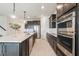 Modern kitchen with stainless steel appliances, granite countertops, and a large island at 5226 Northern Flicker Dr, St Cloud, FL 34771