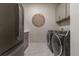 Laundry room equipped with modern washer, dryer, and sleek gray cabinetry at 5226 Northern Flicker Dr, St Cloud, FL 34771