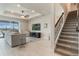 Relaxing living room featuring wood-look floors, a ceiling fan, and a staircase with decorative railing at 5226 Northern Flicker Dr, St Cloud, FL 34771
