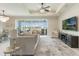 Spacious living room with elegant chandelier, ceiling fan, and sliding doors to the patio at 5226 Northern Flicker Dr, St Cloud, FL 34771