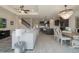 Open-concept living room boasts modern finishes, a decorative ceiling fan, and wood-look floors throughout at 5226 Northern Flicker Dr, St Cloud, FL 34771