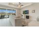 Bright living room featuring a ceiling fan, large windows, and access to the outdoor patio at 5226 Northern Flicker Dr, St Cloud, FL 34771