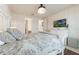 Comfortable main bedroom with decorative headboard, neutral walls, and an overhead lighting fixture at 5226 Northern Flicker Dr, St Cloud, FL 34771