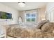 Comfortable main bedroom with decorative headboard, neutral walls, and bright window at 5226 Northern Flicker Dr, St Cloud, FL 34771
