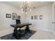 Bright office space with unique light fixture, neutral walls, and dark wood desk and chair at 5226 Northern Flicker Dr, St Cloud, FL 34771