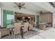 Covered outdoor patio with dining and seating areas overlooking the pool and lake at 5226 Northern Flicker Dr, St Cloud, FL 34771