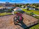 Community playground features a modern play structure with slides, set in a secure, fenced area with shade at 5226 Northern Flicker Dr, St Cloud, FL 34771