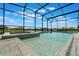 Beautiful screened-in pool and spa overlooking a serene lake at 5226 Northern Flicker Dr, St Cloud, FL 34771