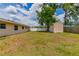 Spacious backyard featuring a storage shed, partial fence, and a lush tree at 5822 Flori Ln, Orlando, FL 32808