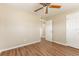 Bedroom featuring wood-look floors, a ceiling fan, and access to a closet and hallway at 5822 Flori Ln, Orlando, FL 32808