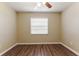 Bright bedroom with neutral walls, wood-style floors, and a window with blinds for privacy at 5822 Flori Ln, Orlando, FL 32808