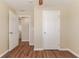 A bright bedroom featuring wood-style floors, with a view into another room at 5822 Flori Ln, Orlando, FL 32808