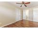 A comfortable bedroom with dark wood-style floors and a view into the bathroom at 5822 Flori Ln, Orlando, FL 32808
