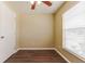 A cozy bedroom with dark wood-style floors, neutral walls, and a ceiling fan for added comfort at 5822 Flori Ln, Orlando, FL 32808