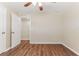 A neutral bedroom with wood-style floors and a view into another room at 5822 Flori Ln, Orlando, FL 32808
