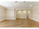 Open-concept living room features wood-look floors, archway to another room, and neutral paint at 5822 Flori Ln, Orlando, FL 32808