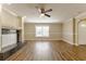 Large living room with wood-look floors, a fireplace, a big window and an entry doorway at 5822 Flori Ln, Orlando, FL 32808