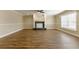 Spacious living room with a decorative fireplace, wood-look floors, and bright natural light at 5822 Flori Ln, Orlando, FL 32808