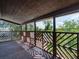 Expansive wooden deck featuring a decorative railing system and a view of lush greenery at 601 Blackstone Ave, Deltona, FL 32725