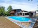 Outdoor oasis featuring a large pool, screened-in porch and balcony overlooking a spacious backyard at 601 Blackstone Ave, Deltona, FL 32725