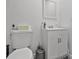 Clean bathroom with a white vanity, toilet, and sleek gray trash bin at 601 Blackstone Ave, Deltona, FL 32725