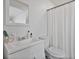Bright bathroom featuring a clean white vanity and a shower with a white shower curtain at 601 Blackstone Ave, Deltona, FL 32725