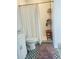 Cozy bathroom featuring decorative tiled floors and a walk-in shower with a wooden bench at 601 Blackstone Ave, Deltona, FL 32725