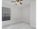 Minimalist bedroom featuring a window, neutral walls and light wood-look flooring at 601 Blackstone Ave, Deltona, FL 32725