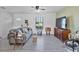 Comfortable living room with stylish decor, large window, and modern gray vinyl flooring at 601 Blackstone Ave, Deltona, FL 32725