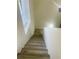 Ascending staircase with wood-look steps offers a bright, modern transition between levels at 601 Blackstone Ave, Deltona, FL 32725