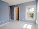Sun-lit room with two doorways, white-wood-look tile floors, and a window at 6512 Swissco Dr # 1428, Orlando, FL 32822