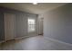 Neutral bedroom features wood-look floors, natural light, and closet at 6512 Swissco Dr # 1428, Orlando, FL 32822