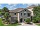 Charming multi-story condo with neutral stucco, white trim, and manicured landscaping under a blue sky at 6512 Swissco Dr # 1428, Orlando, FL 32822