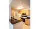 Charming kitchen featuring wood cabinets, black granite countertops, and modern appliances at 6512 Swissco Dr # 1428, Orlando, FL 32822