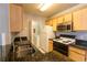 Cozy kitchen with black granite counters, stainless steel appliances, and wooden cabinets at 6512 Swissco Dr # 1428, Orlando, FL 32822
