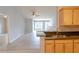 Open-concept living area with tiled floors, a ceiling fan, and a glimpse of the adjacent kitchen at 6512 Swissco Dr # 1428, Orlando, FL 32822