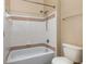 Clean bathroom featuring a shower and tub combination, light tile, and a convenient shower head at 6611 Time Square Ave # 103, Orlando, FL 32835