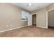 Comfortable bedroom with carpet flooring, neutral walls, a ceiling fan and a well-sized closet space at 6611 Time Square Ave # 103, Orlando, FL 32835