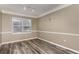 Well-lit dining area featuring wood floors, a large window, and stylish trim throughout the room at 6611 Time Square Ave # 103, Orlando, FL 32835