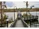View from the dock shows a gazebo on a lake, surrounded by trees and a cloudy sky at 6611 Time Square Ave # 103, Orlando, FL 32835