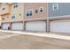 View of garages in a multi-Gathering home, showing the building's facade and street access at 6611 Time Square Ave # 103, Orlando, FL 32835