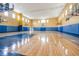 Spacious gymnasium featuring basketball hoops, hardwood floors, and natural light from multiple windows at 6611 Time Square Ave # 103, Orlando, FL 32835