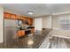 Kitchen featuring stainless steel appliances, a breakfast bar with granite countertops and wood cabinets at 6611 Time Square Ave # 103, Orlando, FL 32835