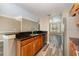 Open-concept kitchen featuring a breakfast bar with granite countertops and stainless steel appliances at 6611 Time Square Ave # 103, Orlando, FL 32835