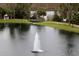 Scenic lake view with a fountain in the center, surrounded by lush greenery and a gazebo on the shore at 6611 Time Square Ave # 103, Orlando, FL 32835