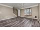 Spacious living room with wood-look floors, a ceiling fan, and a window seat at 6611 Time Square Ave # 103, Orlando, FL 32835