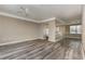 Spacious living room featuring gray wood floors, neutral paint, and an open-concept layout perfect for modern living at 6611 Time Square Ave # 103, Orlando, FL 32835
