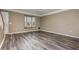 Living room featuring wood-look floors, a bay window with a window seat, and a ceiling fan at 6611 Time Square Ave # 103, Orlando, FL 32835