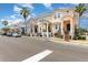 Street view featuring a row of colorful two-story townhomes, each with covered porches and manicured landscaping at 6611 Time Square Ave # 103, Orlando, FL 32835